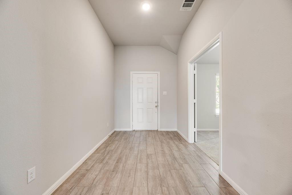 14216 Aberavon Drive Pilot Point, TX 76258 - Photo 4 of 19 Entryway with wood-finish tile flooring, light neutral wall tones, and a recessed lighting fixture