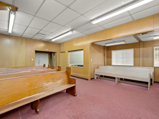 a spacious bedroom with a bed and a window