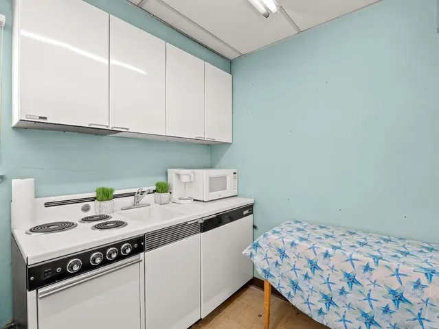 a kitchen with a sink cabinets and appliances