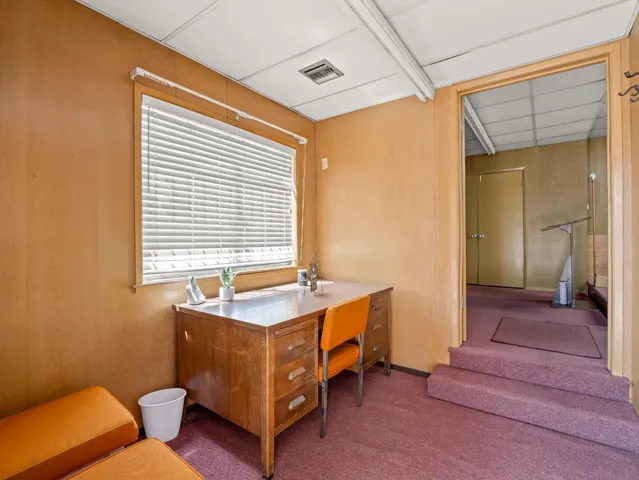 a bedroom with bed and a window