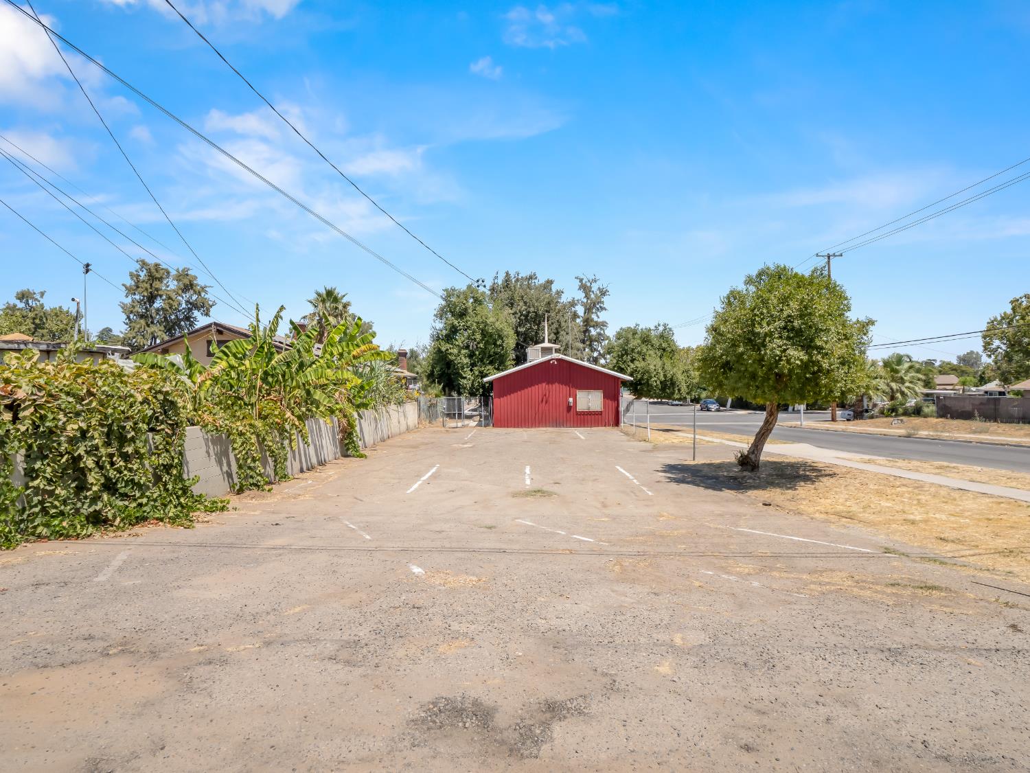 701 Mayor Avenue Fresno, CA 93706 - Photo 26 of 28 a white house with a yard and a large tree