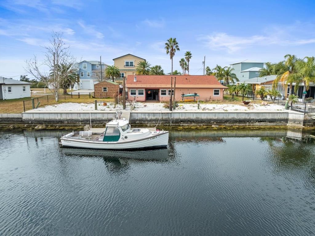4102 Des Prez Court Hernando Beach, FL 34607 - Photo 17 of 52 a view of swimming pool with outdoor seating and lake view