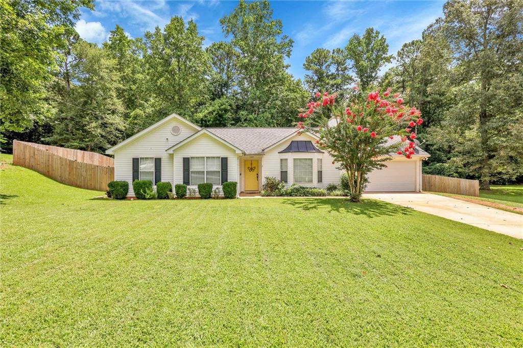 7258 Hummingbird Lane Winston, GA 30187 - Photo 1 of 1 a front view of a house with a garden
