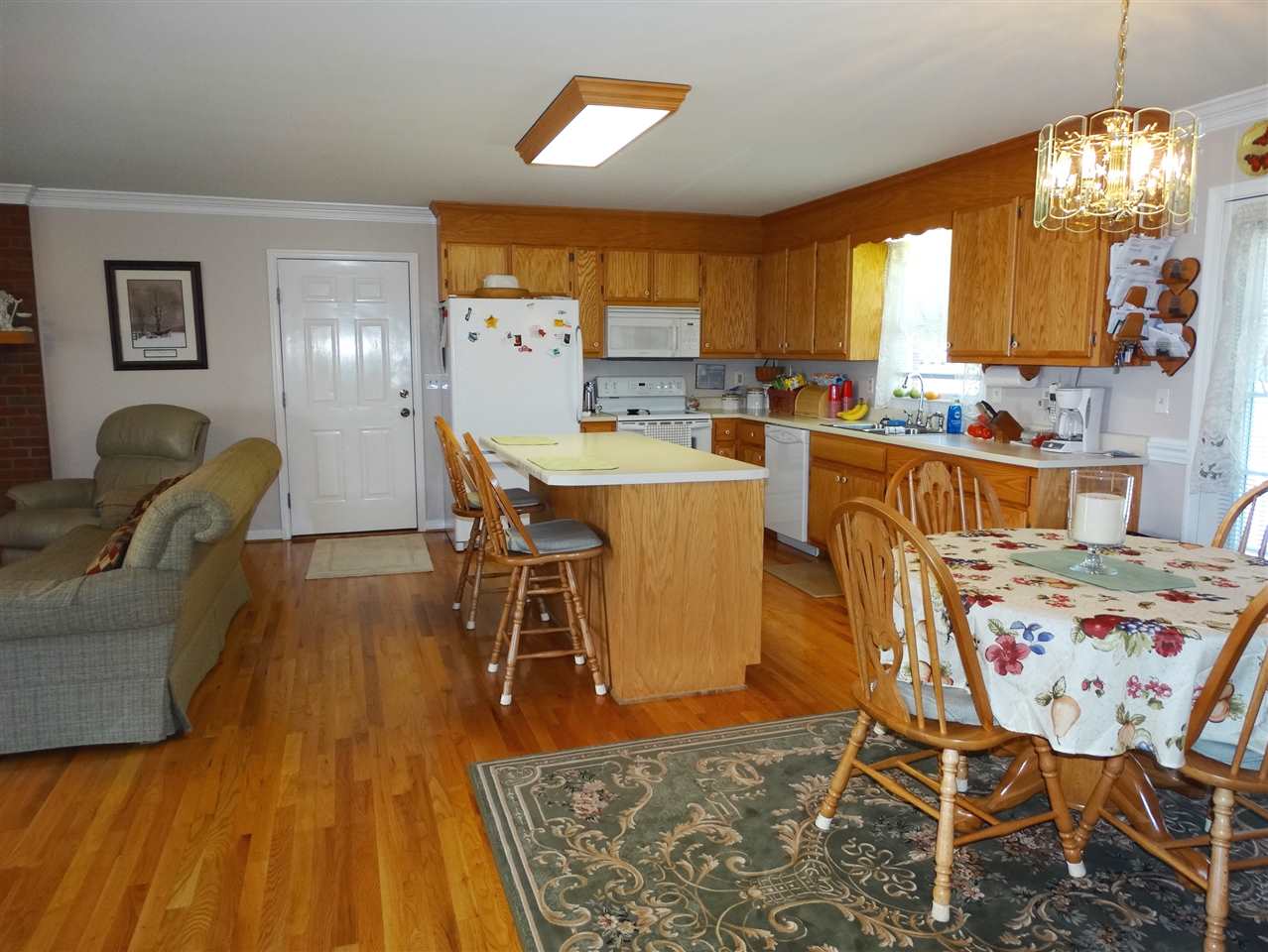 324 Good Hope Church Road Aroda, VA 22709 - Photo 15 of 32 a dining room with wooden floor and a chandelier