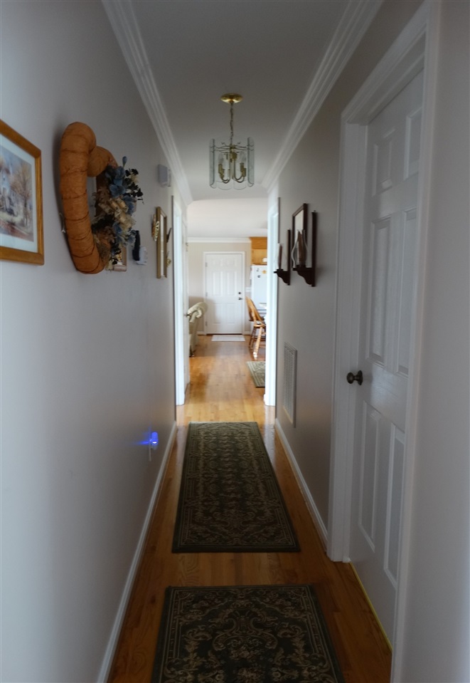 324 Good Hope Church Road Aroda, VA 22709 - Photo 19 of 32 a hallway with wooden floor a chandelier