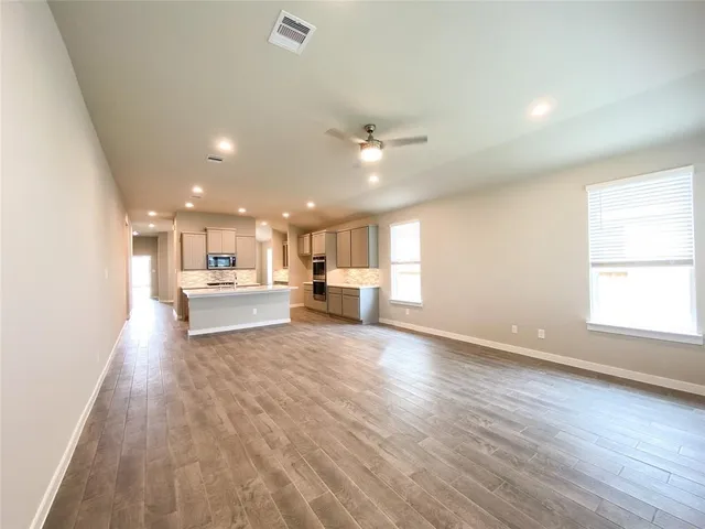 a view of kitchen with kitchen island sink refrigerator and window
