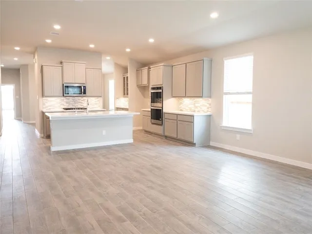 a view of kitchen with wooden floor and windows
