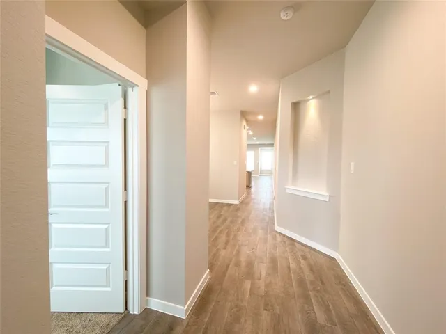 a view of hallway with wooden floor