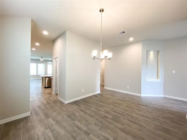 a view of a room with wooden floor