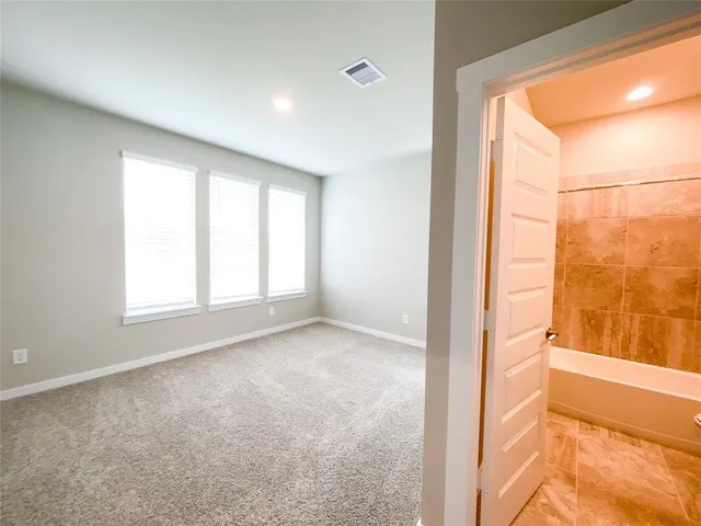 a view of an empty room and a window