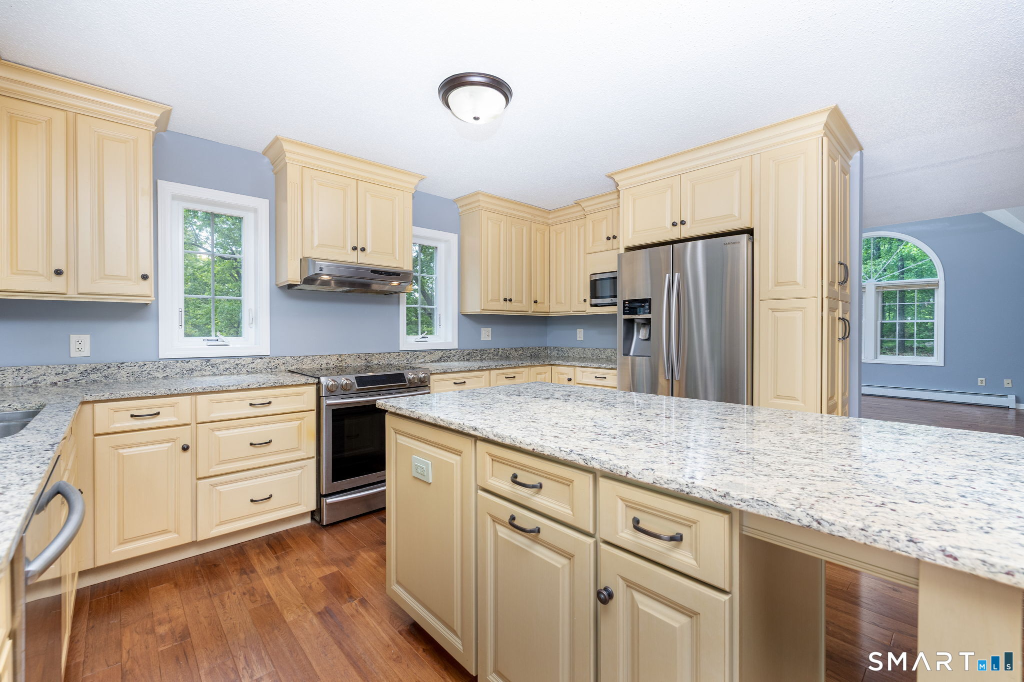 175 Vernon Street Manchester, CT 06042 - Photo 7 of 38 a kitchen with granite countertop a refrigerator sink stove and cabinets
