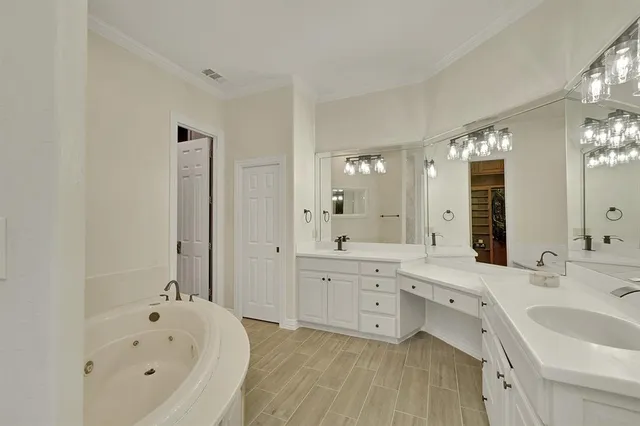 a view of a livingroom with a chandelier fan and windows