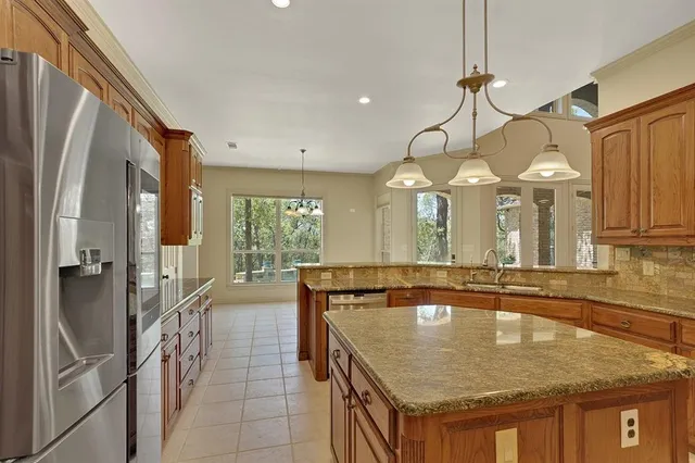 a bathroom with a granite countertop sink a large mirror and a shower