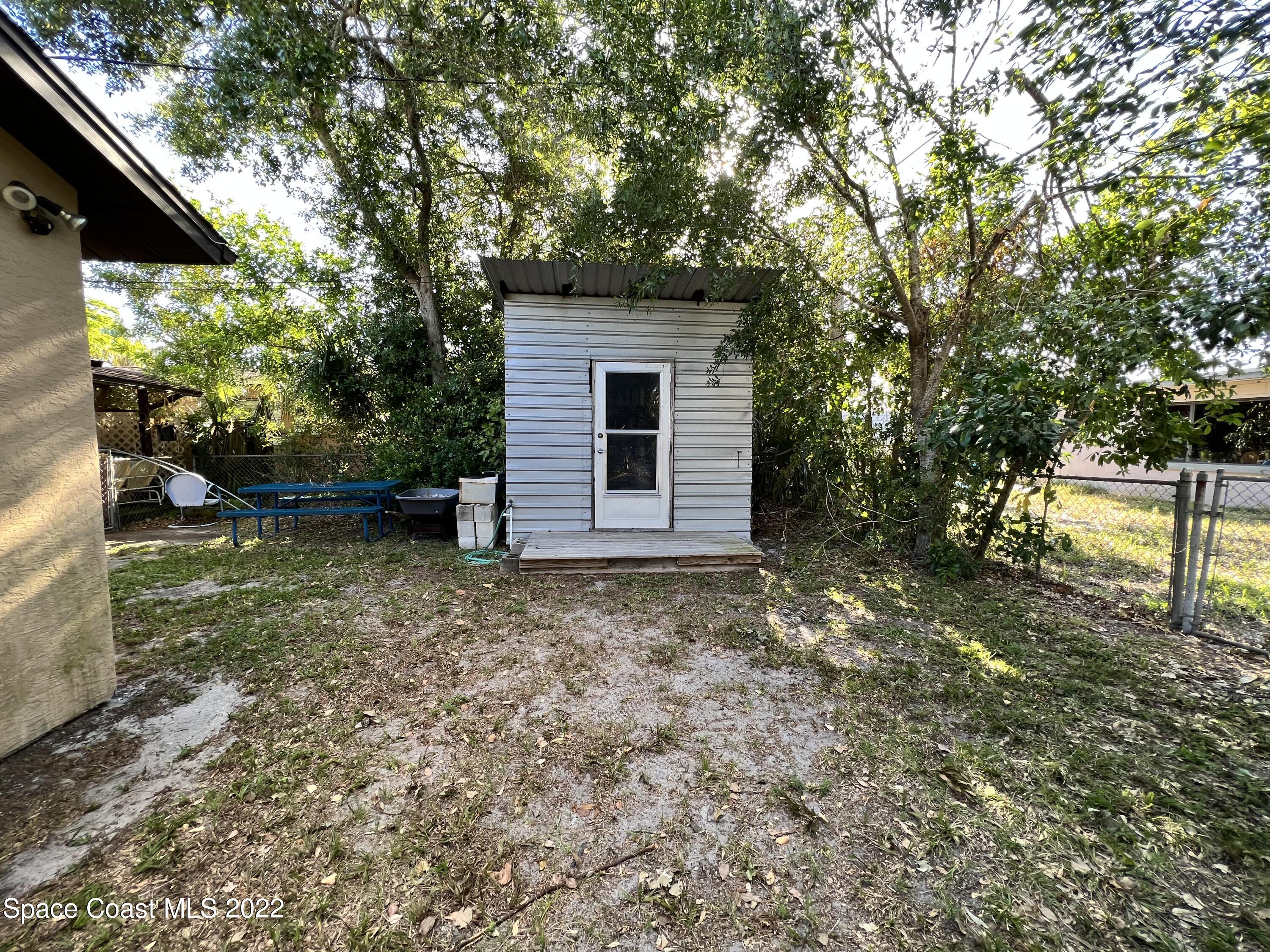 974 Macco Road Cocoa, FL 32927 - Photo 12 of 12 a backyard of a house with lots of green space
