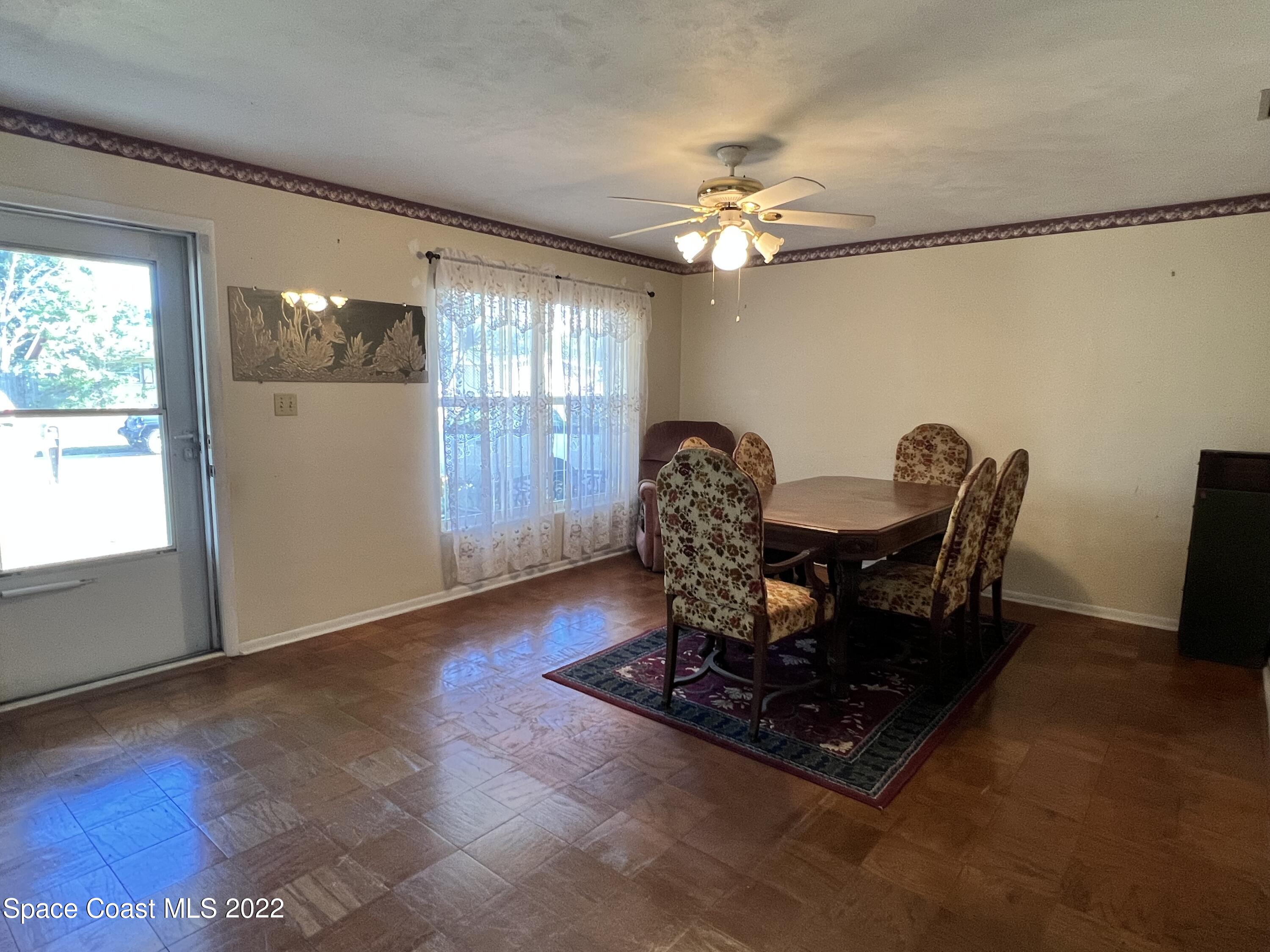 974 Macco Road Cocoa, FL 32927 - Photo 2 of 12 a living room with furniture a chandelier and a window