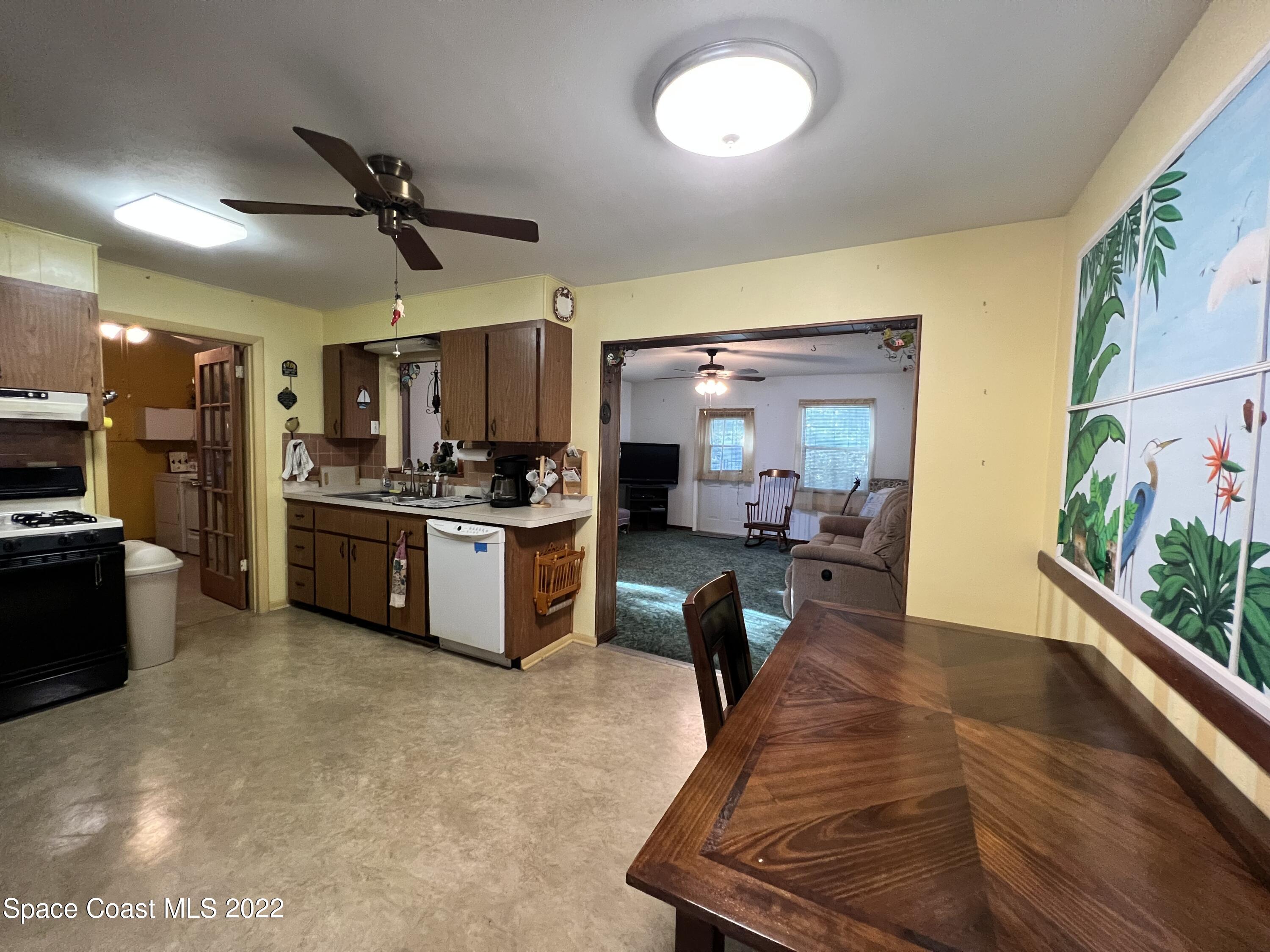 974 Macco Road Cocoa, FL 32927 - Photo 3 of 12 a living room with stainless steel appliances kitchen island granite countertop furniture and a kitchen view