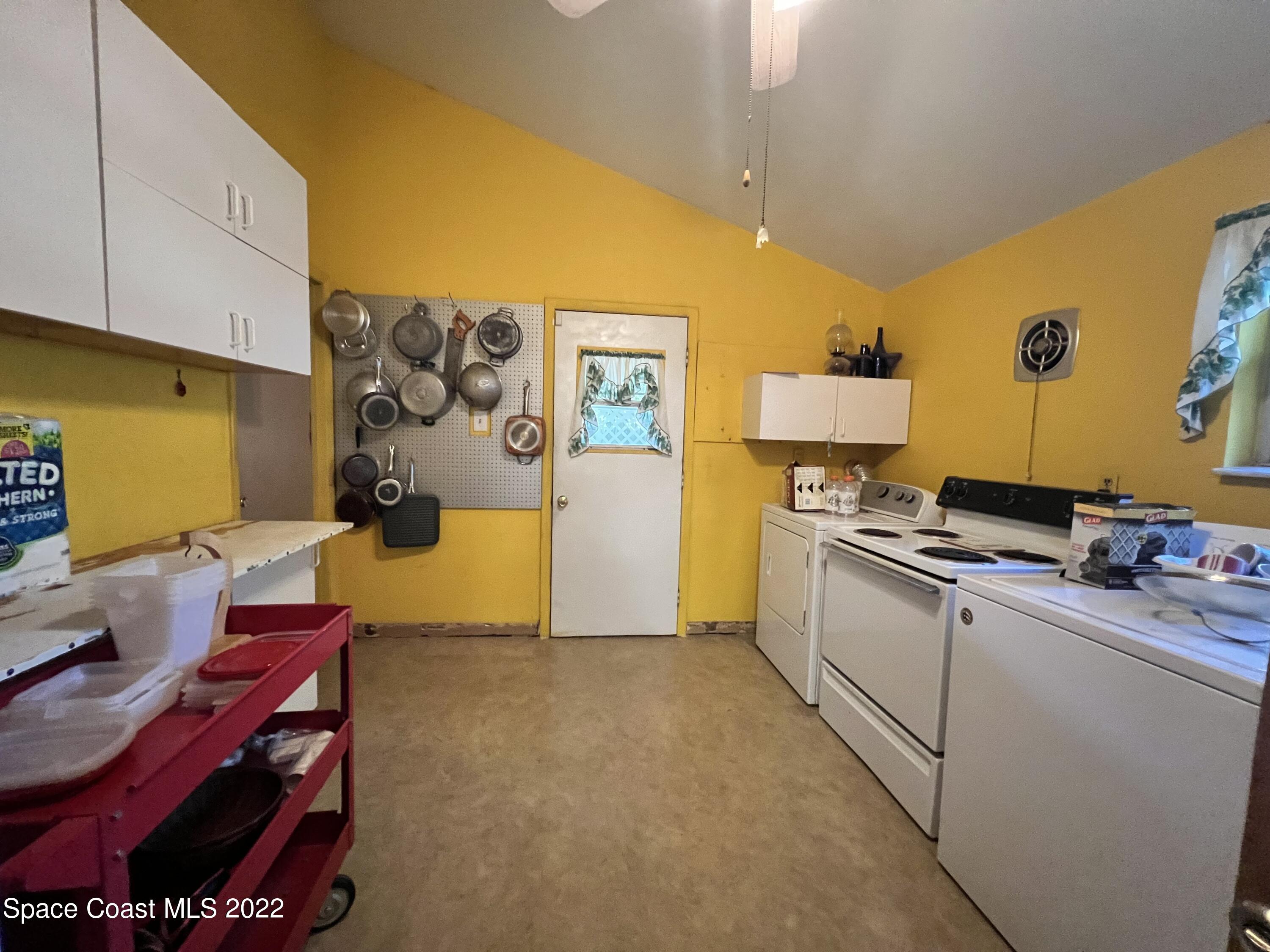 974 Macco Road Cocoa, FL 32927 - Photo 6 of 12 a kitchen with stainless steel appliances granite countertop a sink and cabinets
