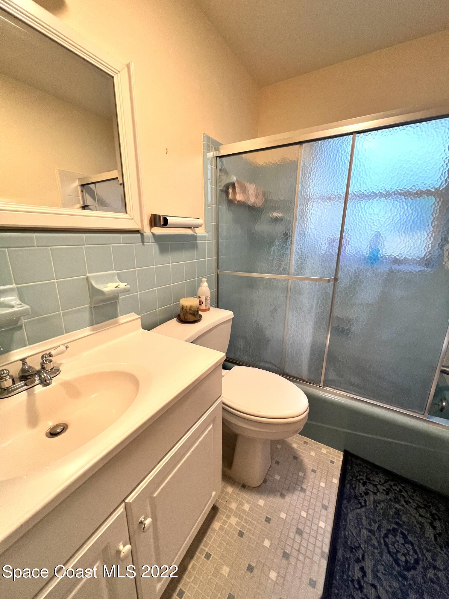 974 Macco Road Cocoa, FL 32927 - Photo 7 of 12 a bathroom with a sink a toilet and a mirror