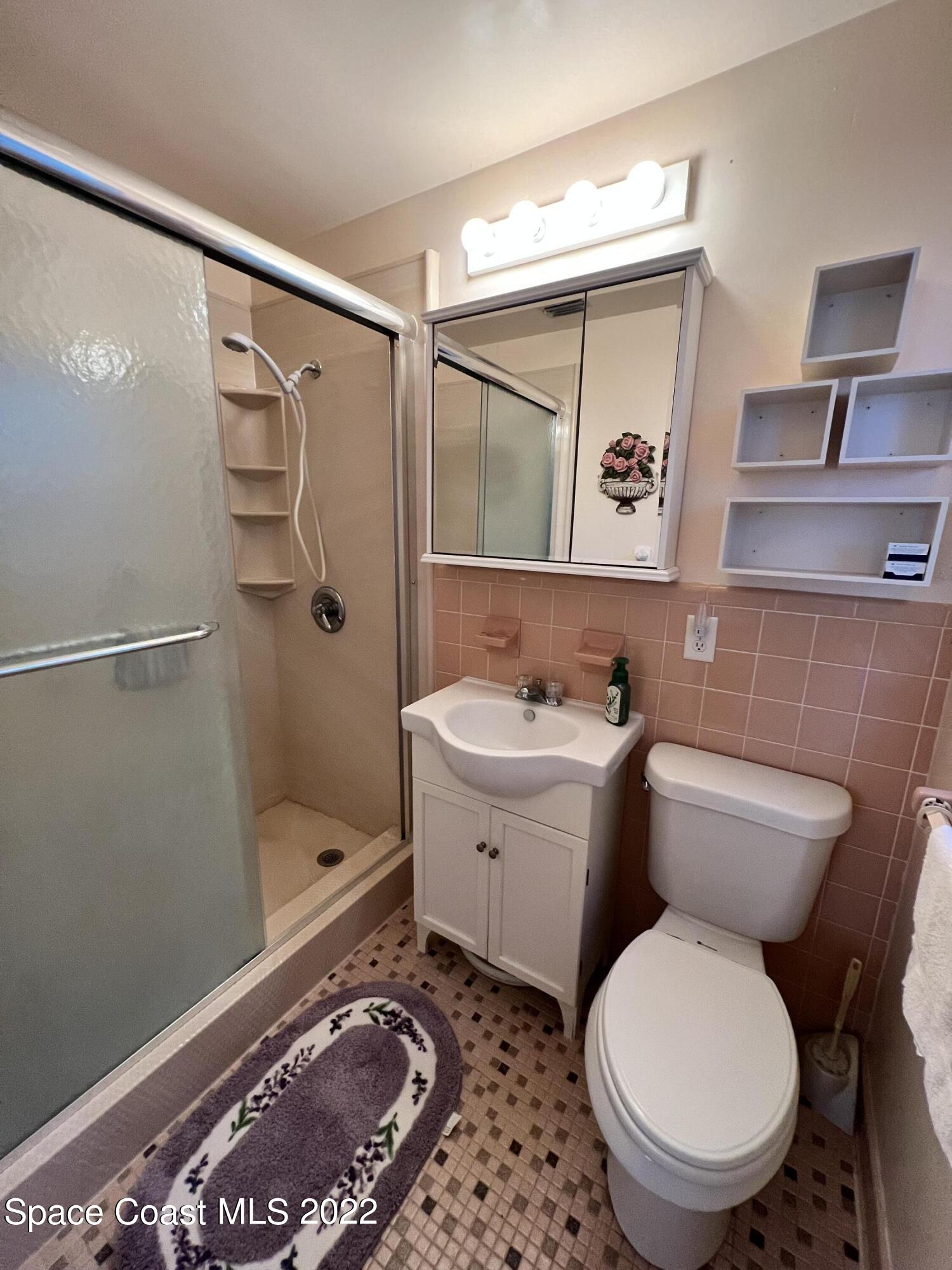 974 Macco Road Cocoa, FL 32927 - Photo 10 of 12 a bathroom with a toilet sink and shower