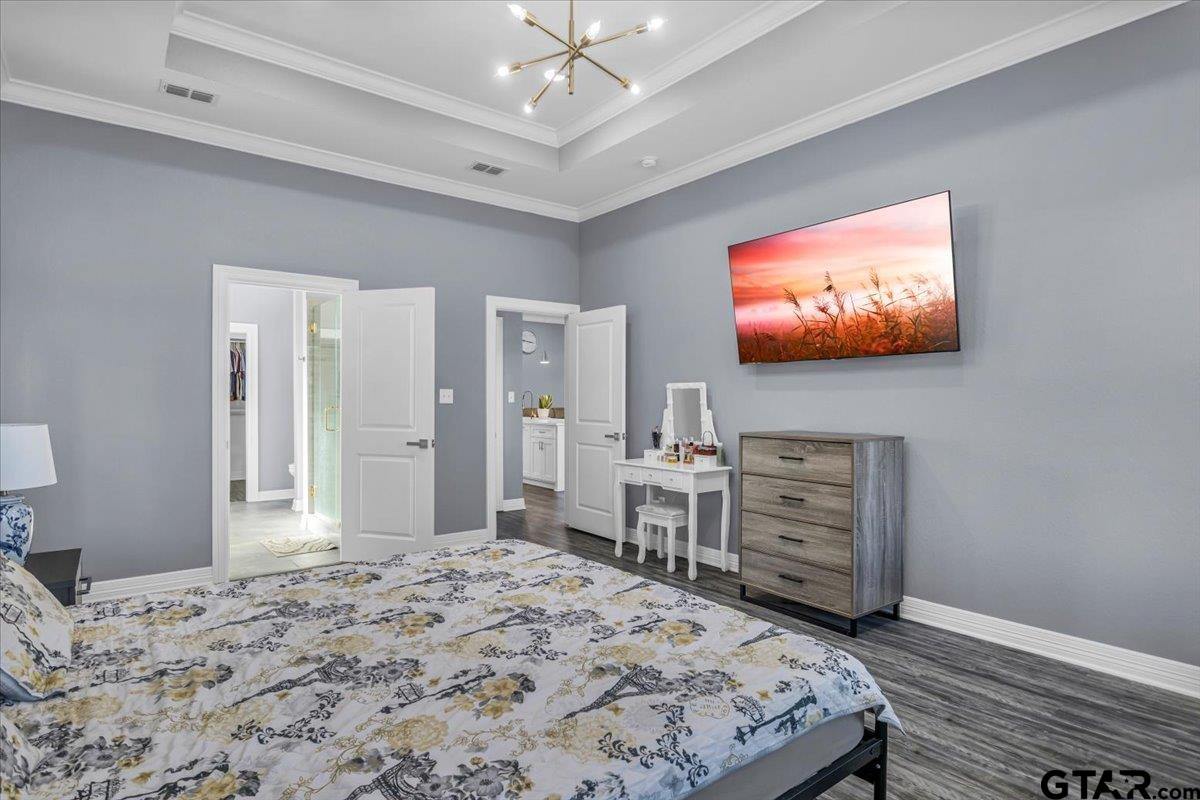 1603 Elk River Road Tyler, TX 75703 - Photo 18 of 43 a bedroom with a bed and a flat screen tv