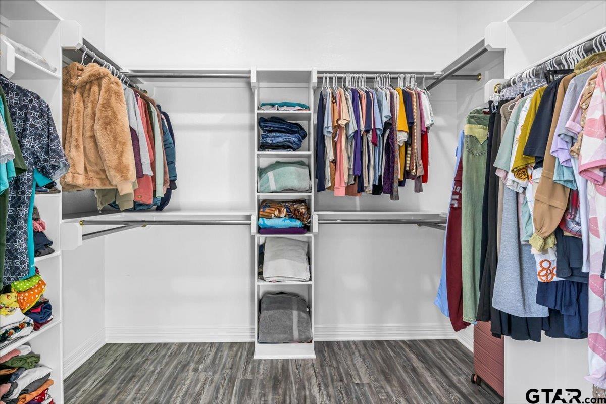 1603 Elk River Road Tyler, TX 75703 - Photo 23 of 43 a view of walk in closet with clothes and shoes