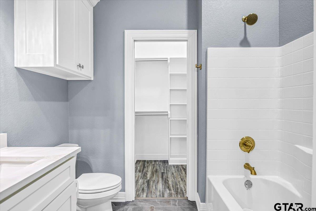 1603 Elk River Road Tyler, TX 75703 - Photo 27 of 43 a bathroom with a sink a toilet and shower