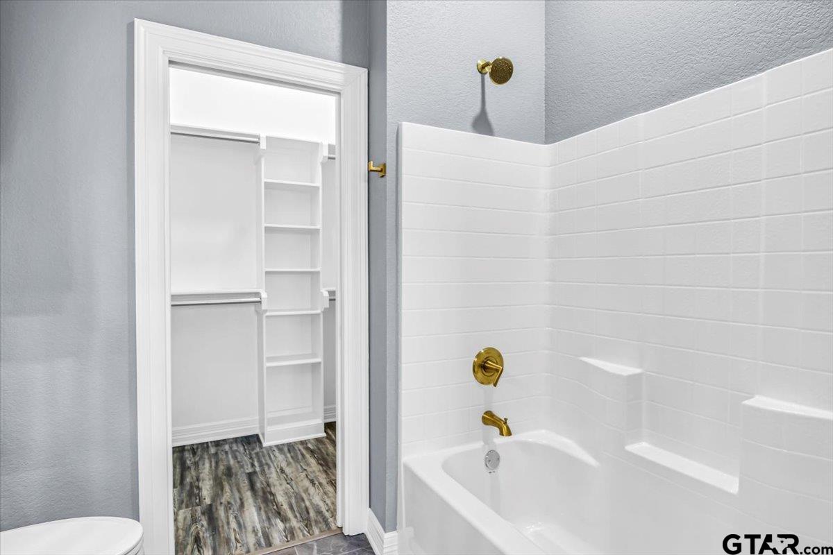 1603 Elk River Road Tyler, TX 75703 - Photo 29 of 43 a bathroom with a bathtub and a toilet