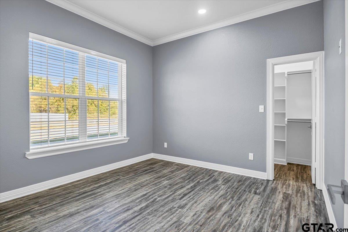 1603 Elk River Road Tyler, TX 75703 - Photo 30 of 43 a view of an empty room with wooden floor and a window