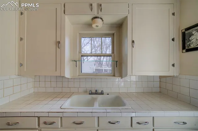 a kitchen with a sink cabinets and window