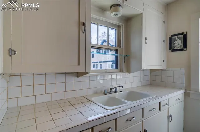 a kitchen with a sink cabinets and window