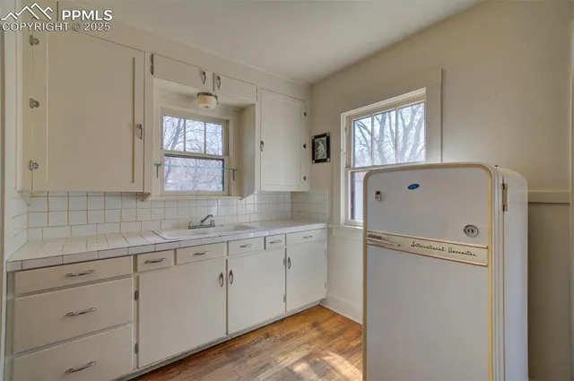 a view of a kitchen with dishwasher and a refrigerator