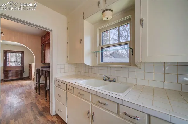 a spacious bathroom with a sink mirror and window