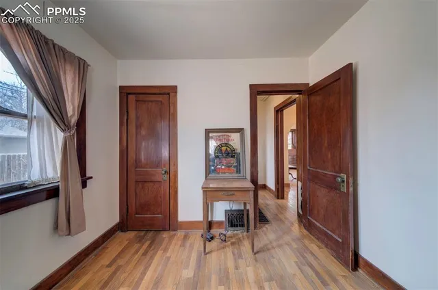 a view of a hallway with wooden floor and staircase