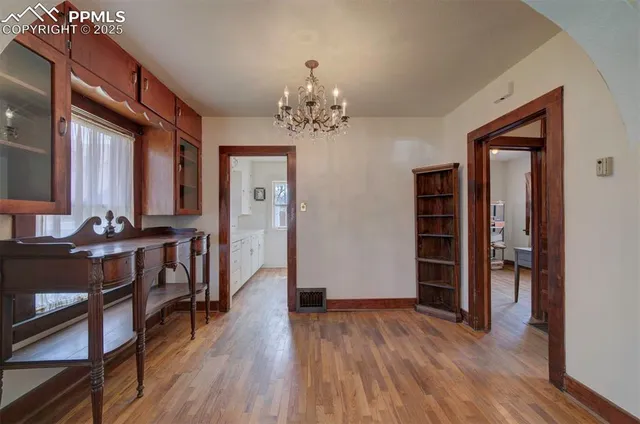 a view of a room with wooden floor and staircase