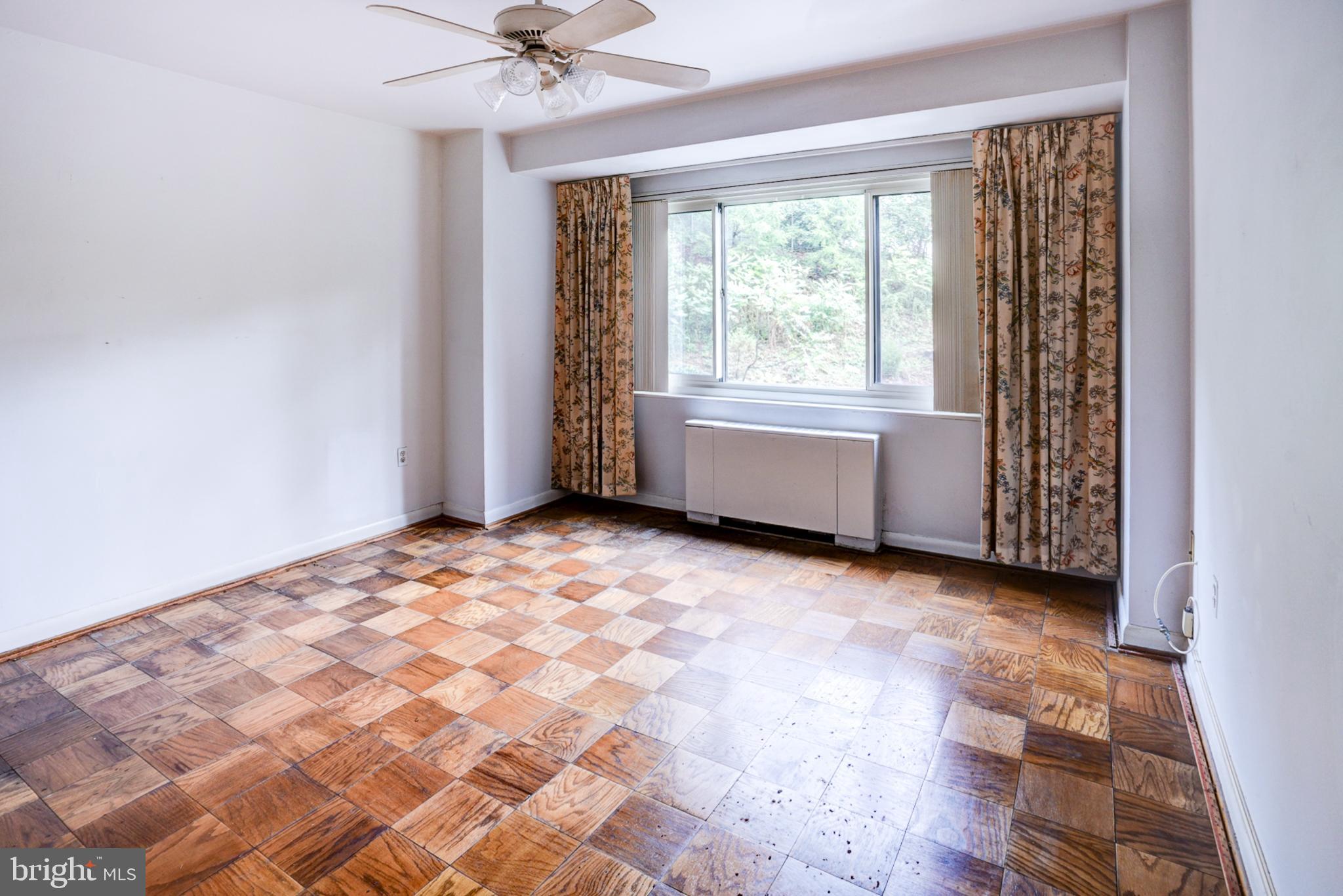 4201 Cathedral Avenue Northwest, Unit 201E Washington, DC 20016 - Photo 25 of 66 a view of an empty room with a window