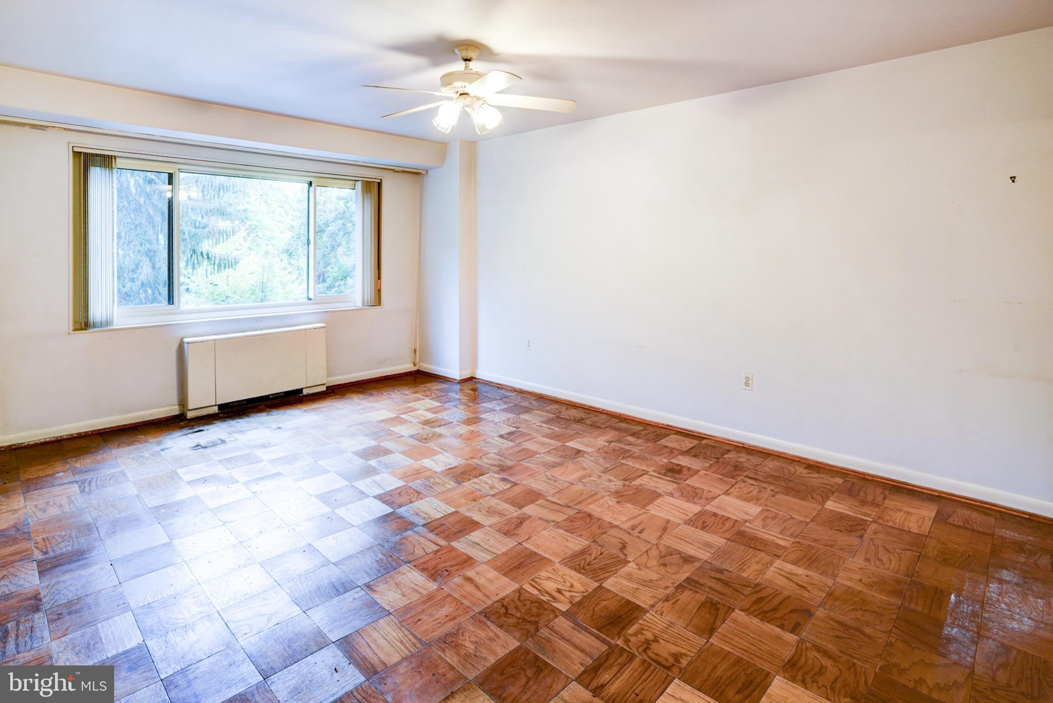 4201 Cathedral Avenue Northwest, Unit 201E Washington, DC 20016 - Photo 29 of 66 wooden floor in an empty room with a window