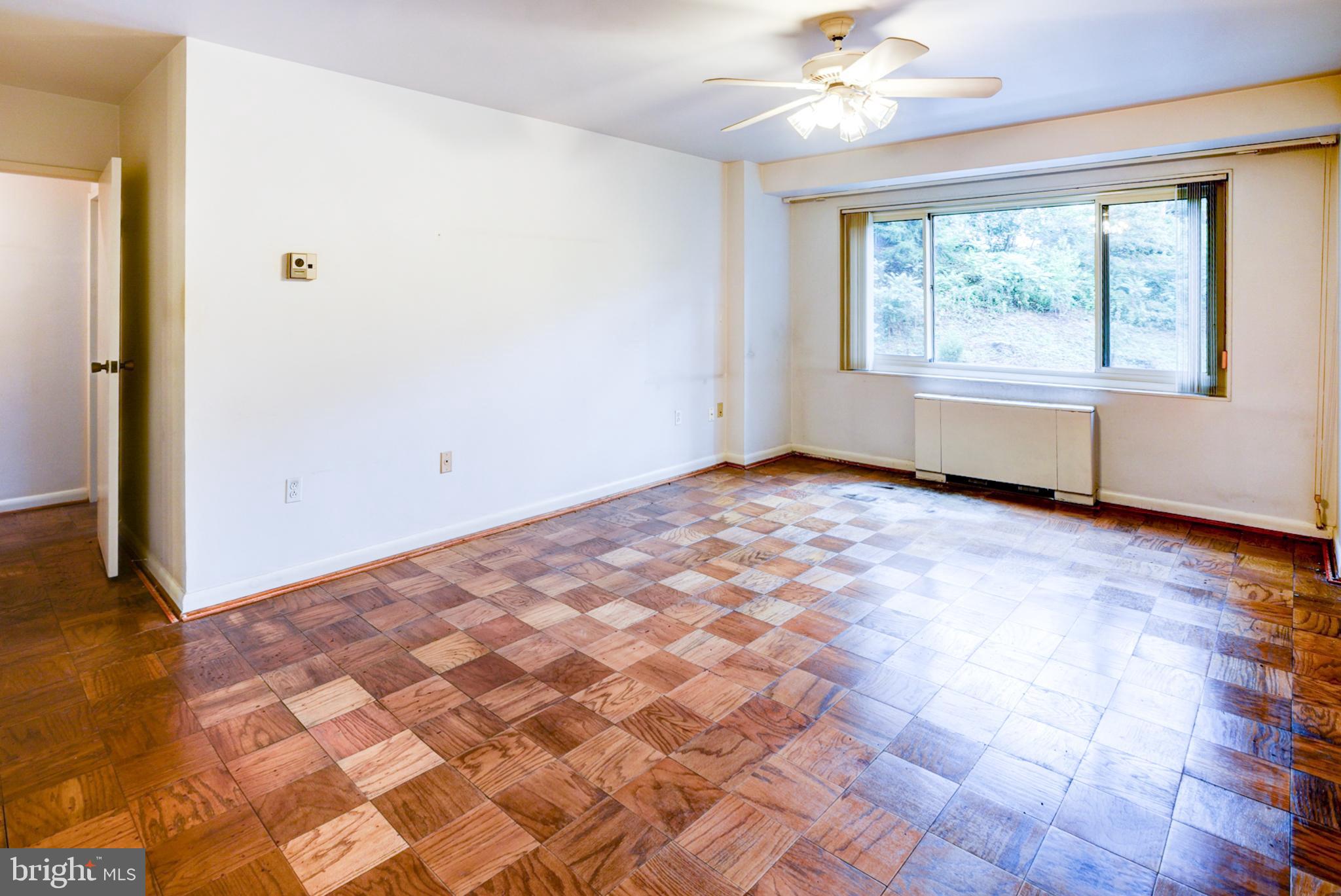 4201 Cathedral Avenue Northwest, Unit 201E Washington, DC 20016 - Photo 30 of 66 an empty room with windows and ceiling fan