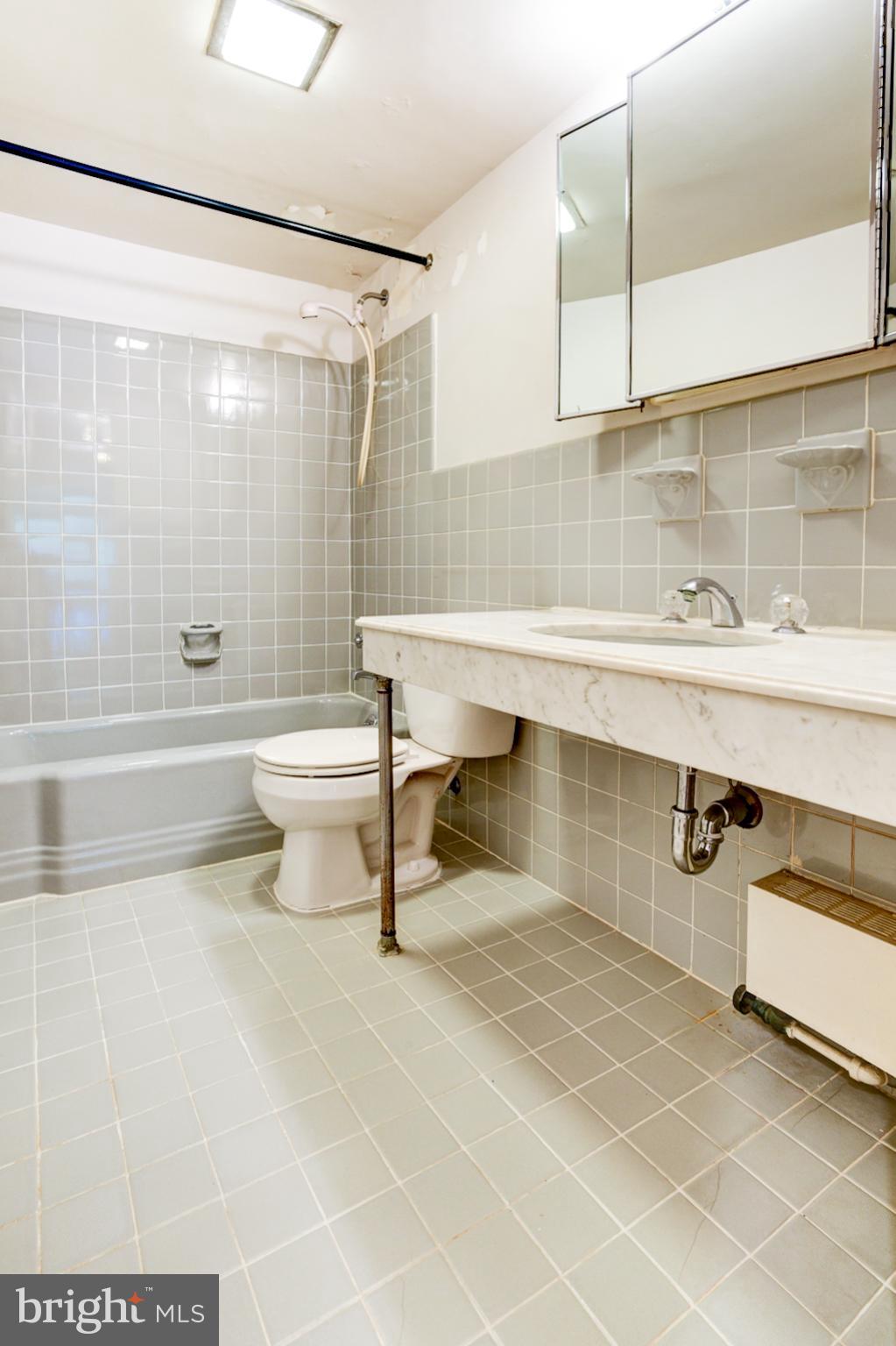 4201 Cathedral Avenue Northwest, Unit 201E Washington, DC 20016 - Photo 36 of 66 a bathroom with a toilet a sink and bathtub