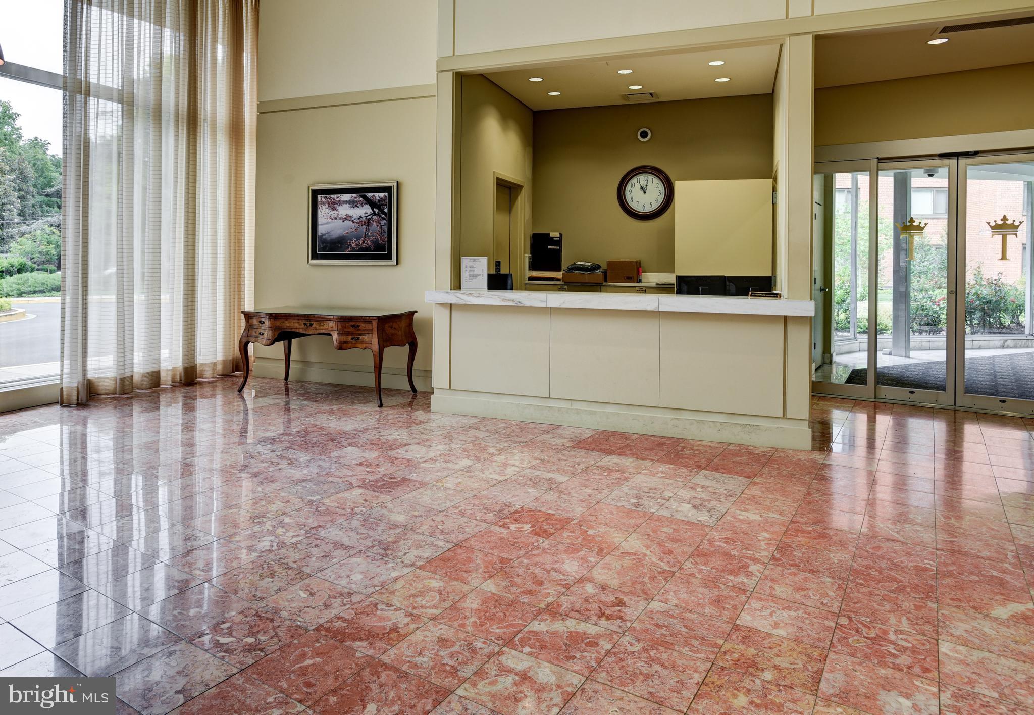 4201 Cathedral Avenue Northwest, Unit 201E Washington, DC 20016 - Photo 49 of 66 a view of a lobby with furniture and floor to ceiling window