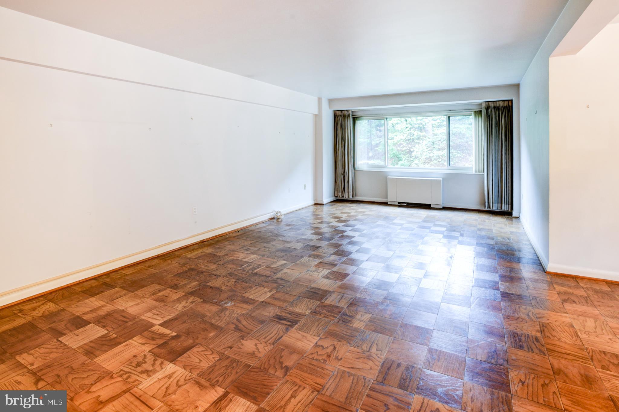 4201 Cathedral Avenue Northwest, Unit 201E Washington, DC 20016 - Photo 6 of 66 a view of an empty room with a window