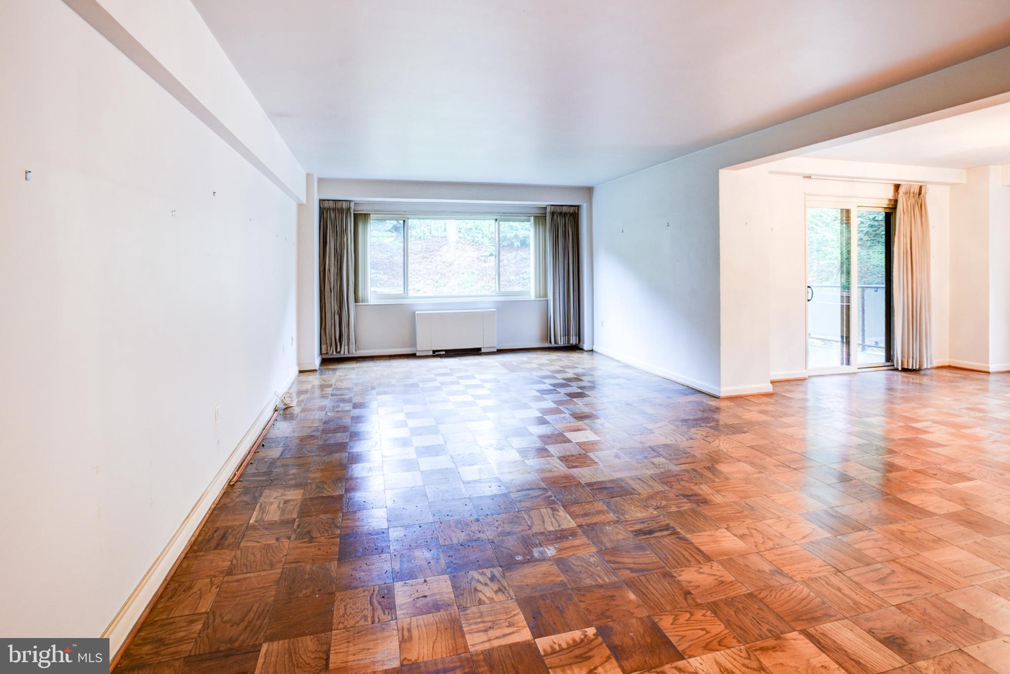 4201 Cathedral Avenue Northwest, Unit 201E Washington, DC 20016 - Photo 8 of 66 a view of empty room with wooden floor and fan