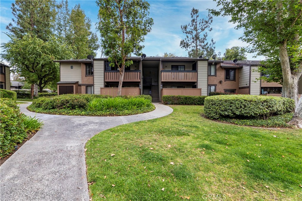 20702 El Toro Road, Unit 178 Lake Forest, CA 92630 - Photo 1 of 30 a front view of a house with a yard and porch