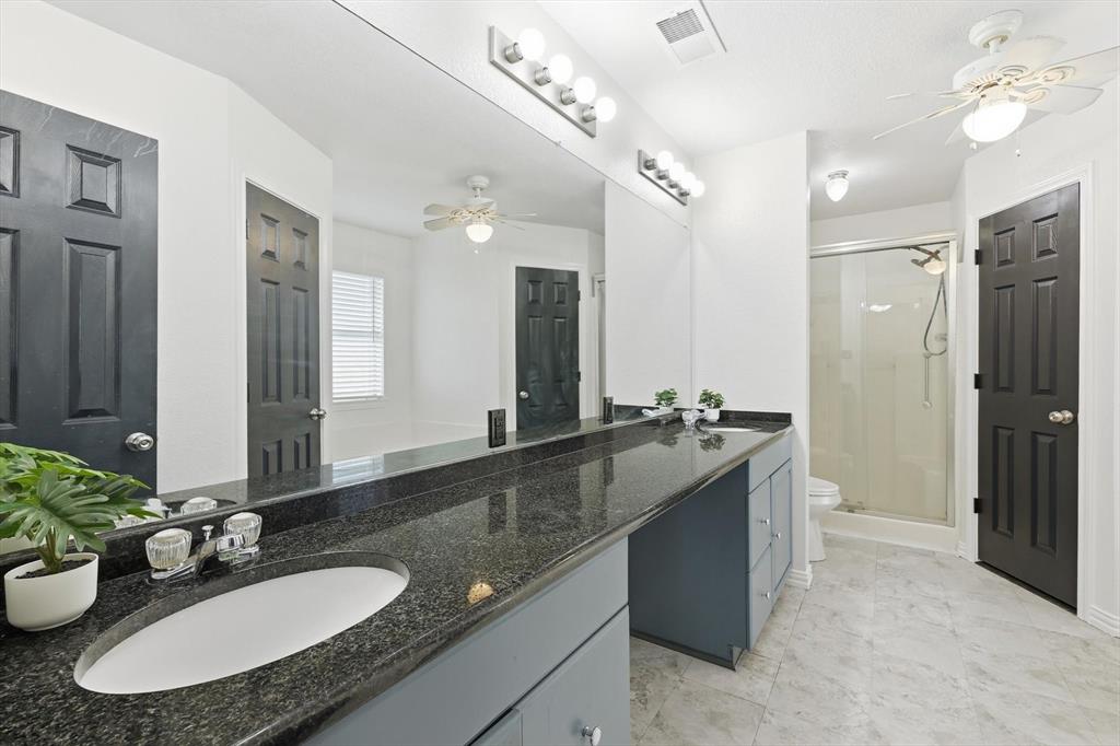 217 Seay Road Italy, TX 76651 - Photo 20 of 38 Bathroom with a ceiling fan, double vanity, and a stall shower