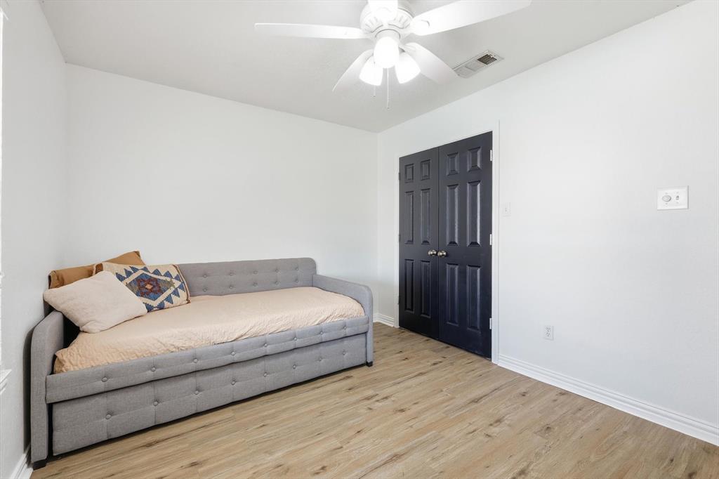 217 Seay Road Italy, TX 76651 - Photo 28 of 38 Bedroom with light wood finished floors and ceiling fan