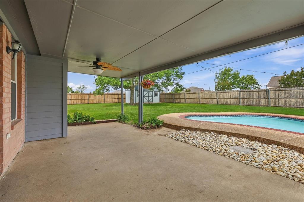 217 Seay Road Italy, TX 76651 - Photo 29 of 38 Fenced backyard with a patio area, a shed, and ceiling fan