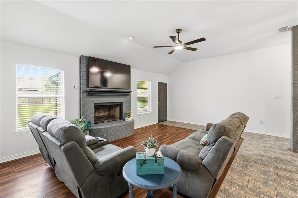 217 Seay Road Italy, TX 76651 - Photo 8 of 38 Living area featuring a brick fireplace, ceiling, plenty of natural light, and a ceiling fan