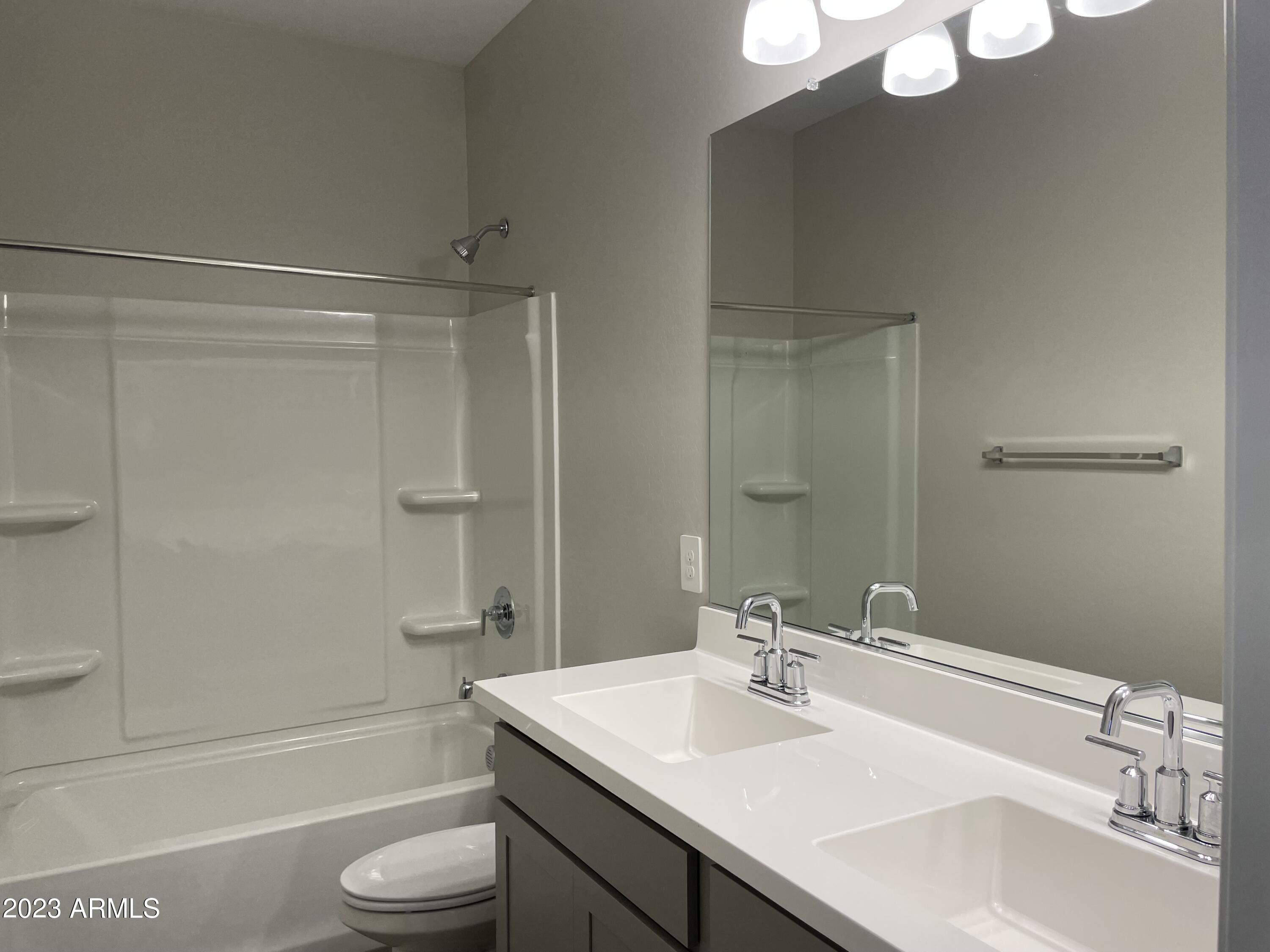 1255 North Arizona Avenue, Unit 1290 Chandler, AZ 85225 - Photo 12 of 13 a bathroom with a sink a toilet and shower