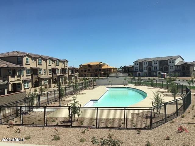 1255 North Arizona Avenue, Unit 1290 Chandler, AZ 85225 - Photo 2 of 13 a view of a swimming pool with a lounge chair