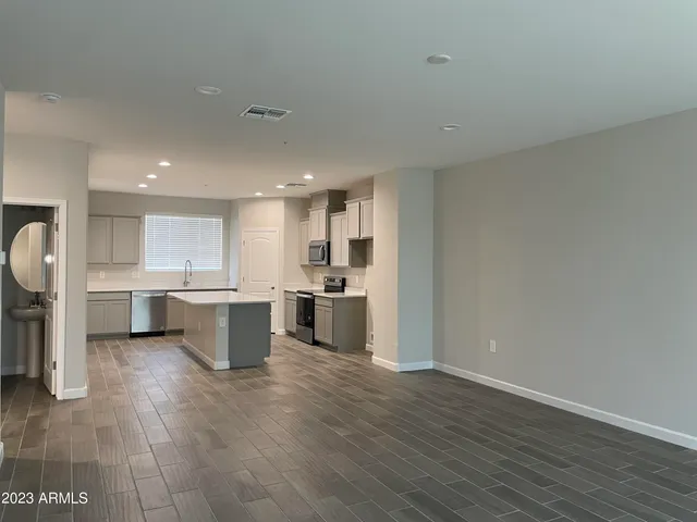 a kitchen with a sink and chairs