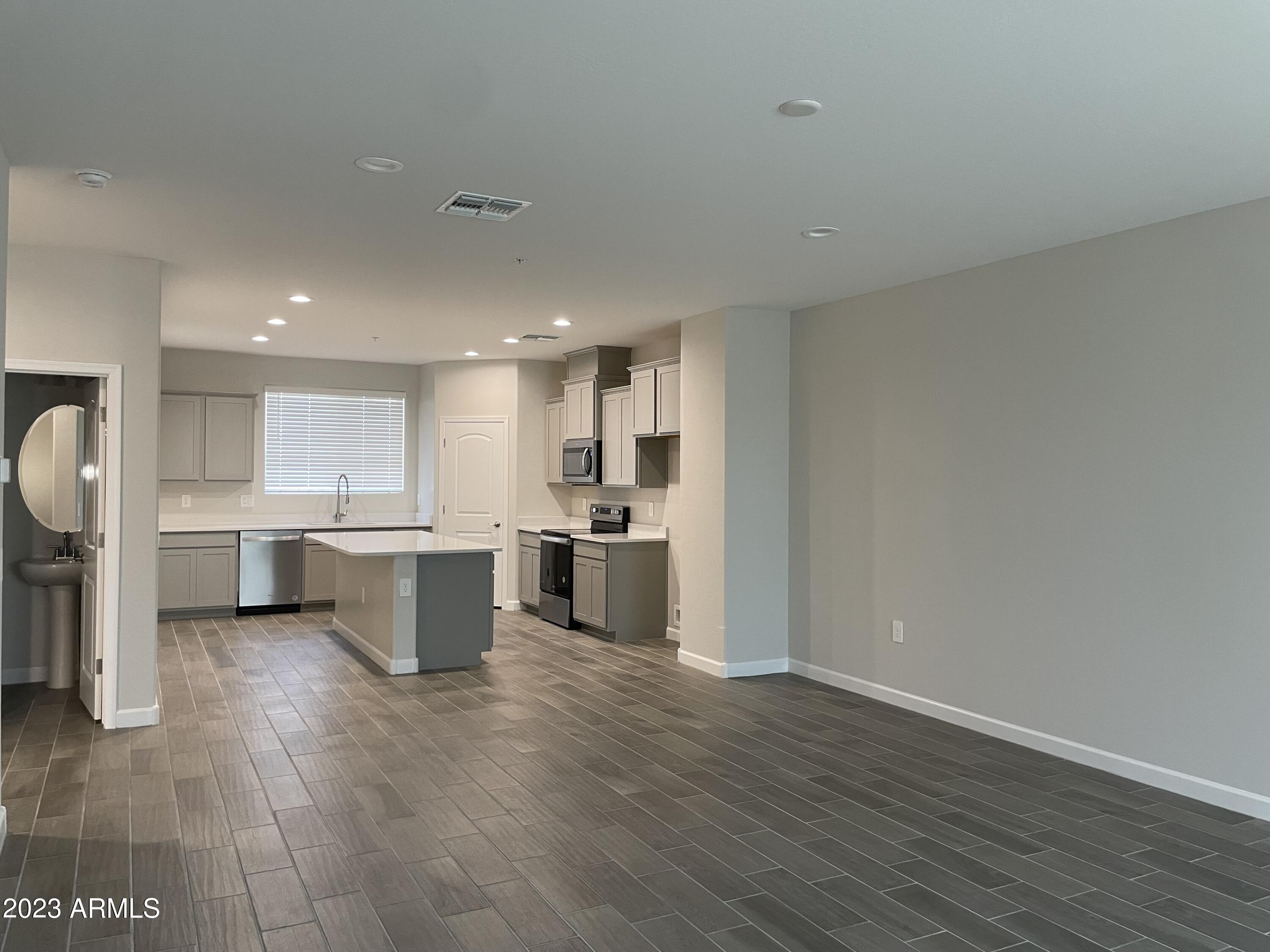 1255 North Arizona Avenue, Unit 1290 Chandler, AZ 85225 - Photo 6 of 13 a kitchen with a sink and chairs